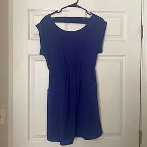Blue dress with pockets and peekaboo hole in back. Defines waist.